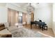 Bright living room with a piano, modern chandelier, and patio access at 10002 Trapper Mountain St, Las Vegas, NV 89178