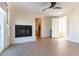 Open-concept room featuring a fireplace, access to a bedroom, and sliding glass doors for indoor-outdoor living at 10002 Trapper Mountain St, Las Vegas, NV 89178