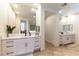 Bright and airy main bathroom with white cabinetry, marble countertops, and dual vanities, creating a spa-like retreat at 10002 Trapper Mountain St, Las Vegas, NV 89178