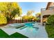 Sparkling pool and spa in a private backyard is framed by lush landscaping and offers a refreshing retreat at 10002 Trapper Mountain St, Las Vegas, NV 89178