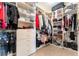 Spacious walk-in closet featuring custom shelving, drawers, and ample hanging space for organized storage at 10002 Trapper Mountain St, Las Vegas, NV 89178