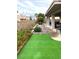 This backyard features a putting green with well-manicured flowerbeds, rock features, and a patio at 1198 Golf Club, Laughlin, NV 89029