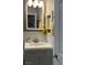 Charming powder room with framed mirror, cabinet and stylish wall decor at 1198 Golf Club, Laughlin, NV 89029
