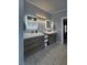 Modern bathroom with double sink vanity, custom mirrors, and decorative lighting fixtures at 1198 Golf Club, Laughlin, NV 89029