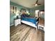 Bedroom with ensuite, ceiling fan, bed and side tables with lamps, and painted blue walls at 1198 Golf Club, Laughlin, NV 89029