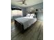 Comfortable bedroom with a bed, ceiling fan, artwork, and natural light at 1198 Golf Club, Laughlin, NV 89029