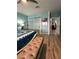 Bedroom with blue walls, view to the ensuite bathroom and closet, and bench at 1198 Golf Club, Laughlin, NV 89029