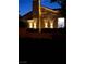 Charming home exterior featuring decorative lighting and well-maintained landscaping at night at 1198 Golf Club, Laughlin, NV 89029