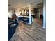 Open-concept kitchen with an island featuring bar seating, sleek countertops, and modern pendant lighting at 1198 Golf Club, Laughlin, NV 89029