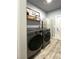 Laundry room with modern washer and dryer, decor, and storage at 1198 Golf Club, Laughlin, NV 89029