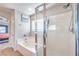 Clean bathroom with a glass-enclosed shower and a separate soaking tub at 1213 High Altitude Ave, North Las Vegas, NV 89032
