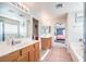 Bright bathroom with double sinks, shower and tub combo, and tile flooring at 1213 High Altitude Ave, North Las Vegas, NV 89032