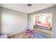 Bright bedroom with connected room featuring carpet flooring and neutral colored walls and natural light at 1213 High Altitude Ave, North Las Vegas, NV 89032