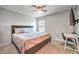 Bedroom with a ceiling fan, carpet flooring, desk and neutral colored walls at 1213 High Altitude Ave, North Las Vegas, NV 89032