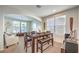 Dining area features a wooden table with seating, bathed in natural light from large windows, perfect for Gathering meals at 1213 High Altitude Ave, North Las Vegas, NV 89032