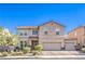 Charming two-story home boasts a tile roof, three-car garage, and manicured landscaping, creating inviting curb appeal at 1213 High Altitude Ave, North Las Vegas, NV 89032