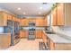 Modern kitchen featuring granite countertops, stainless steel appliances, and tiled flooring at 1213 High Altitude Ave, North Las Vegas, NV 89032