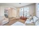Bright living room showcases neutral tones, large windows, and stylish furnishings, creating a comfortable and inviting atmosphere at 1213 High Altitude Ave, North Las Vegas, NV 89032
