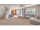 View of the living room showcasing a large sectional sofa, kitchen access, and staircase at 1213 High Altitude Ave, North Las Vegas, NV 89032