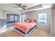 Spacious bedroom features a tray ceiling, ceiling fan, and large windows at 1213 High Altitude Ave, North Las Vegas, NV 89032