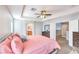 Spacious main bedroom with a ceiling fan, a dresser, and neutral colored walls and natural light at 1213 High Altitude Ave, North Las Vegas, NV 89032