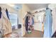 Walk-in closet with built-in shelving and plenty of hanging space with carpet flooring at 1213 High Altitude Ave, North Las Vegas, NV 89032