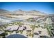 Wide aerial shot of homes in a well planned community against a backdrop of desert mountains at 12168 Dorada Coast Ave, Las Vegas, NV 89138