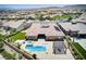 Stunning aerial view of a home featuring a pool, spa, manicured lawn, and desert landscaping at 12168 Dorada Coast Ave, Las Vegas, NV 89138