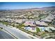 Aerial view of neighborhood featuring pools, backyard patios, and mountain views in distance at 12168 Dorada Coast Ave, Las Vegas, NV 89138