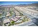 Aerial view showcasing a neighborhood near the mountains with pools and construction sites at 12168 Dorada Coast Ave, Las Vegas, NV 89138