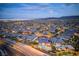 Expansive aerial view of a planned community with many homes, near desert mountains at 12168 Dorada Coast Ave, Las Vegas, NV 89138