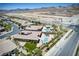 Birds eye view of neighborhood with backyard pools, landscaping, and mountain views at 12168 Dorada Coast Ave, Las Vegas, NV 89138