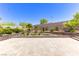 Backyard with low brick retaining wall surrounding desert landscaping with green plants and decorative rocks at 12168 Dorada Coast Ave, Las Vegas, NV 89138