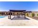 Spacious backyard with a pergola covering an outdoor dining table at 12168 Dorada Coast Ave, Las Vegas, NV 89138