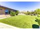 Backyard features artificial turf, desert landscaping, and mountain views at 12168 Dorada Coast Ave, Las Vegas, NV 89138
