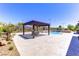 Backyard with a covered patio, outdoor furniture, and an in-ground pool with rock waterfall feature at 12168 Dorada Coast Ave, Las Vegas, NV 89138