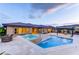 Inviting backyard with pool, hot tub, travertine tile, and covered patio at 12168 Dorada Coast Ave, Las Vegas, NV 89138