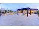 Backyard patio with pergola, travertine tile, pool, and outdoor seating at 12168 Dorada Coast Ave, Las Vegas, NV 89138