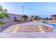 Multi-level backyard showcasing travertine tile, pool, and elegant stone retaining walls at 12168 Dorada Coast Ave, Las Vegas, NV 89138