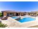 Relaxing backyard featuring a pool, spa and covered patio with seating at 12168 Dorada Coast Ave, Las Vegas, NV 89138