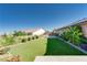 Lush backyard featuring an artificial lawn and mature landscaping for privacy at 12168 Dorada Coast Ave, Las Vegas, NV 89138