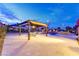 Inviting backyard features a covered patio with an outdoor dining set and desert landscaping at 12168 Dorada Coast Ave, Las Vegas, NV 89138