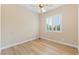 Bedroom with light wood-look floors, a ceiling fan, and window with shutters at 12168 Dorada Coast Ave, Las Vegas, NV 89138