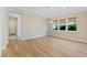 Bright dining room with wood floors, large windows, and elegant chandelier at 12168 Dorada Coast Ave, Las Vegas, NV 89138