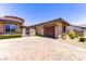 Beautiful stone home featuring a two-car garage and a charming gated courtyard entrance at 12168 Dorada Coast Ave, Las Vegas, NV 89138