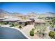 A beautiful single-story home with a circular driveway and desert landscaping against a mountain backdrop at 12168 Dorada Coast Ave, Las Vegas, NV 89138