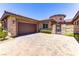 Attractive stone-clad home with a well-manicured front yard and a two-car garage at 12168 Dorada Coast Ave, Las Vegas, NV 89138