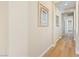 Hallway with light wood-look floors and artwork at 12168 Dorada Coast Ave, Las Vegas, NV 89138