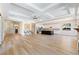 Open-concept with tray ceiling, wood floors, and seamless flow into kitchen at 12168 Dorada Coast Ave, Las Vegas, NV 89138