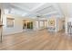 Spacious living room with wood floors, sliding glass doors, and natural lighting at 12168 Dorada Coast Ave, Las Vegas, NV 89138